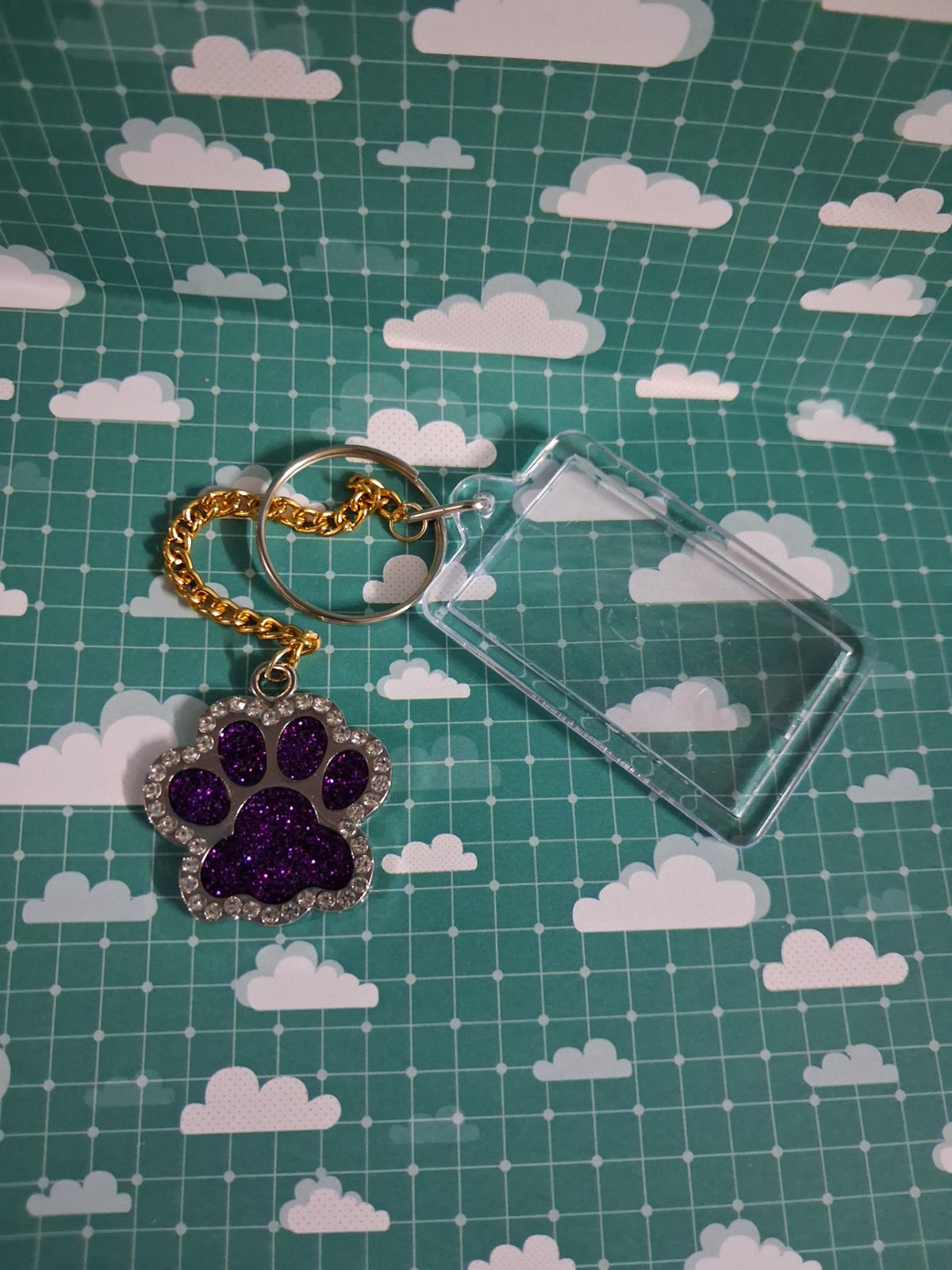 Purple glitter resin paw keyring with gold-coloured chain and clear acrylic photo frame
